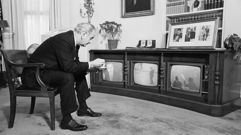 Lyndon Johnson watching the Apollo 8 mission on three televisions.
