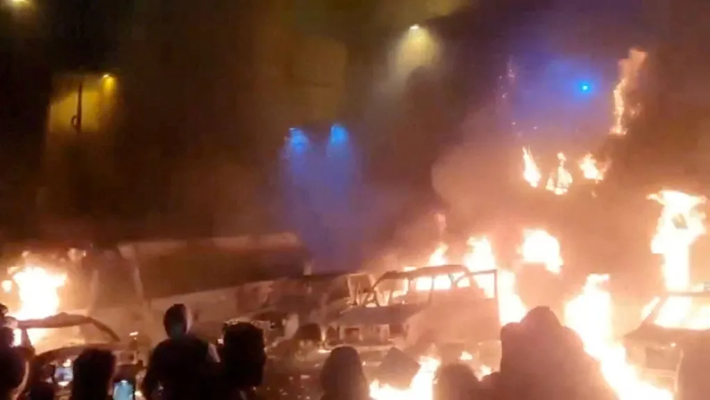 Protesters gather as vehicles burn, amid evolving anti-government unrest, in Tehran, Iran, in this screen grab obtained from a social media video released on January 9, 2026. 