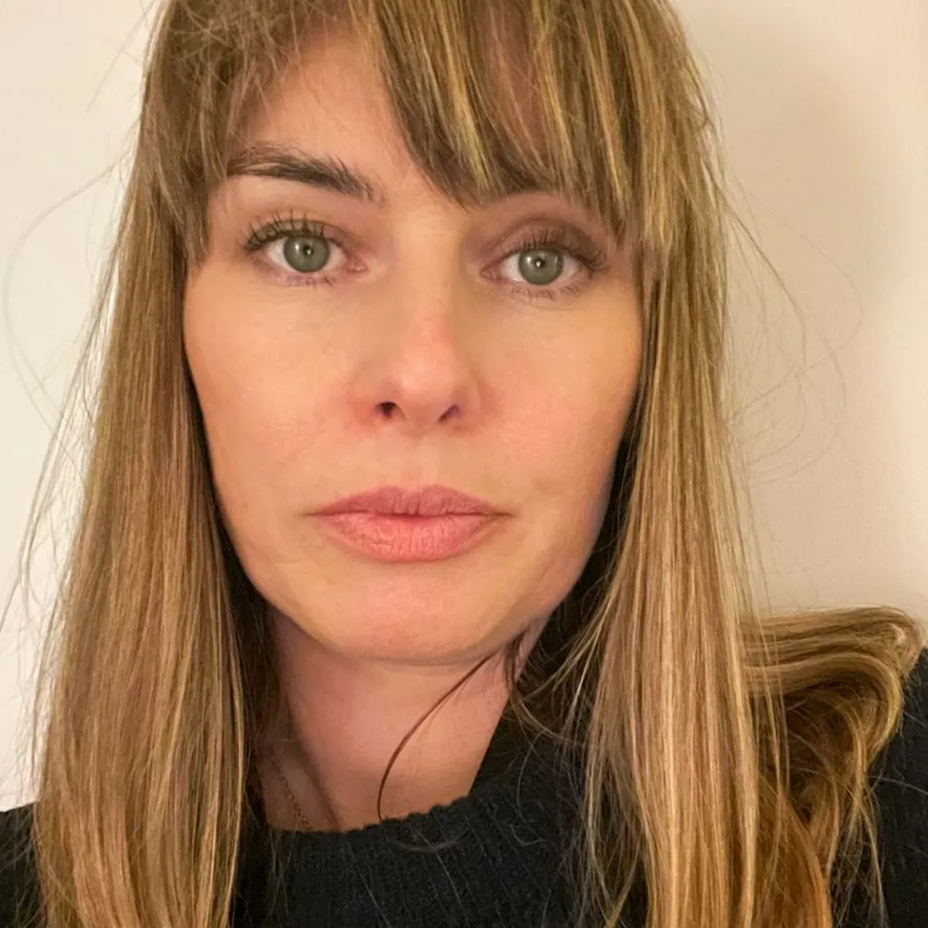 Katie Curran, a woman with green eyes, with blonde shoulder length hair 