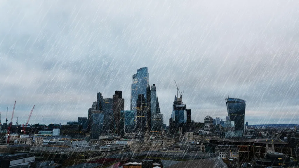 Rain falls over the buildings of the City of London.