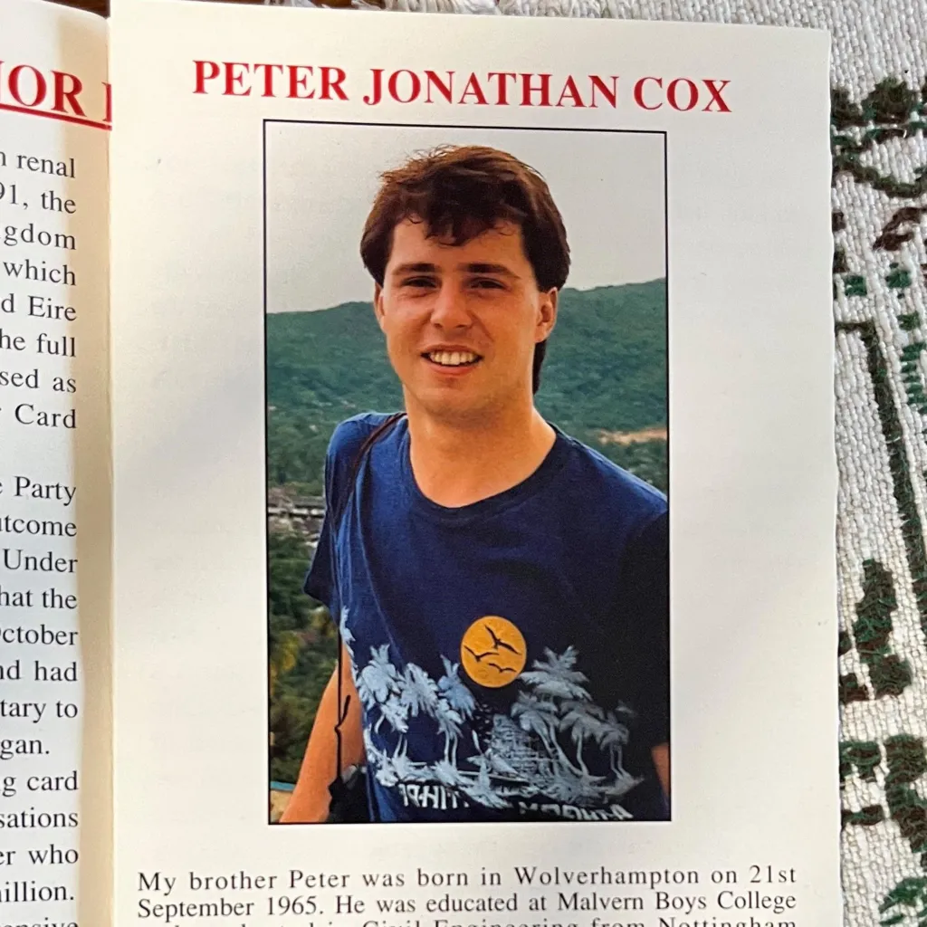 A photo of a leaflet, showing an image of a young man with the name 'Peter Jonathan Cox' in red letters above it.