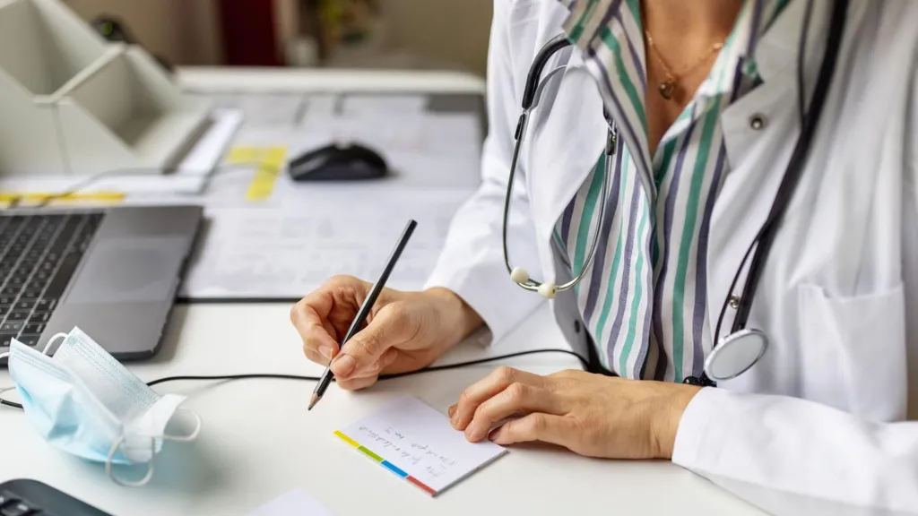 stock image of woman writing prescription