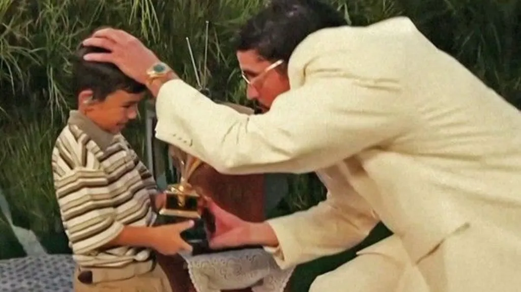 Screenshot from the video showing Bad Bunny giving a boy a trophy 