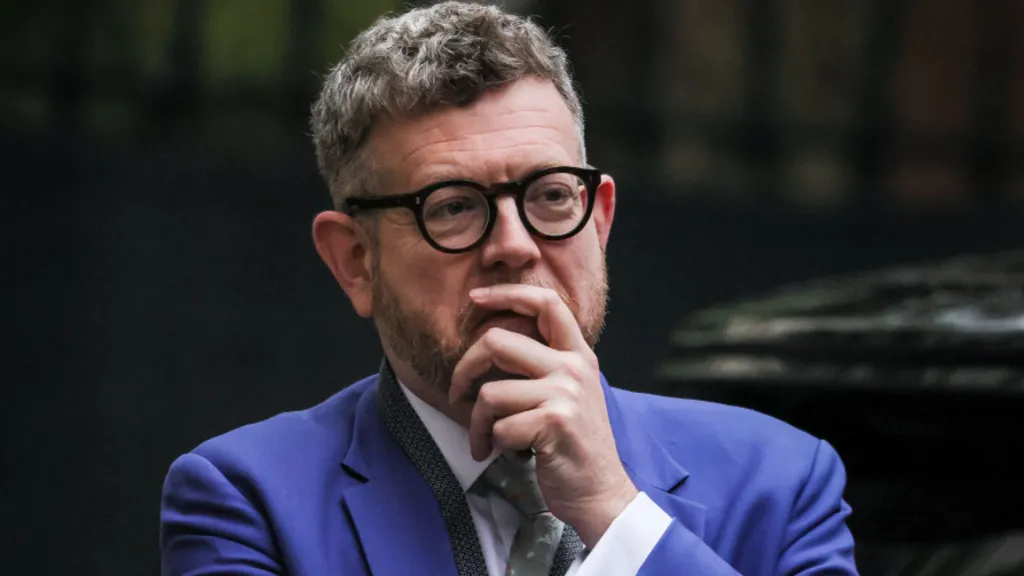 Matthew Doyle wearing a bright blue suit and a white shirt. 