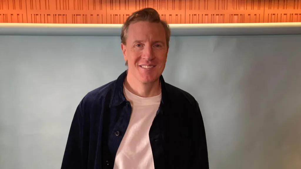 Patrick smiling in the studio as a guest on Ready to Talk