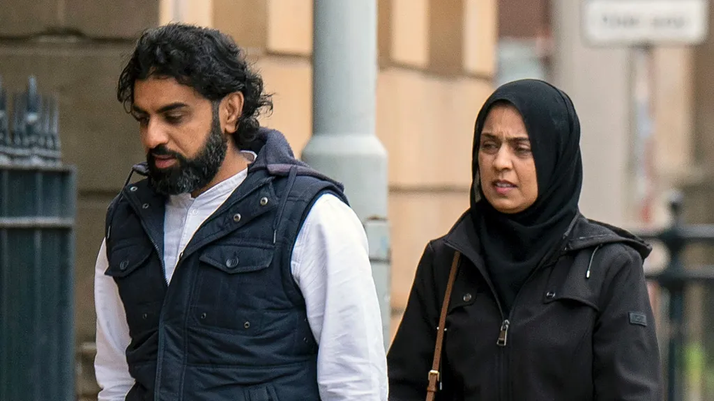 Omer and Attiya Sheikh walking into court ahead of sentencing - they are both wearing dark jackets 