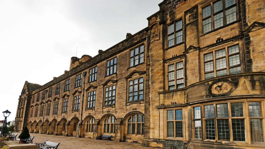 A general view of a Bangor University building, with some seating viewable in the front.