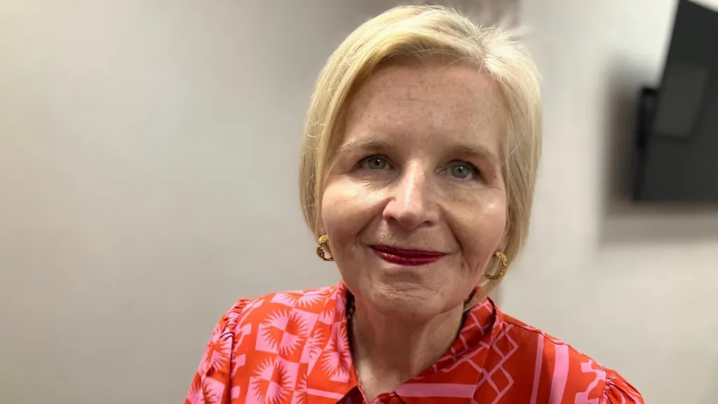 Image of Donna Ockenden. She has blonde hair and is wearing pink/red dress.