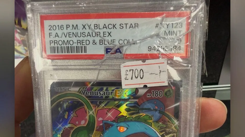 The image shows a Venusaur pokémon Card priced at £700, the case is cracked.