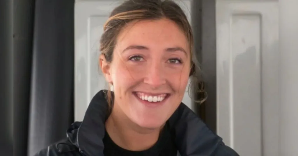 Sophie Rottenberg is smiling at the camera. Her brown hair is tied back off her face and she is wearing a navy outdoor jacket.