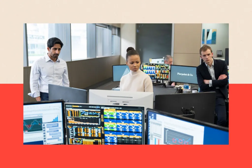 Three people stand in an office, looking into the distance