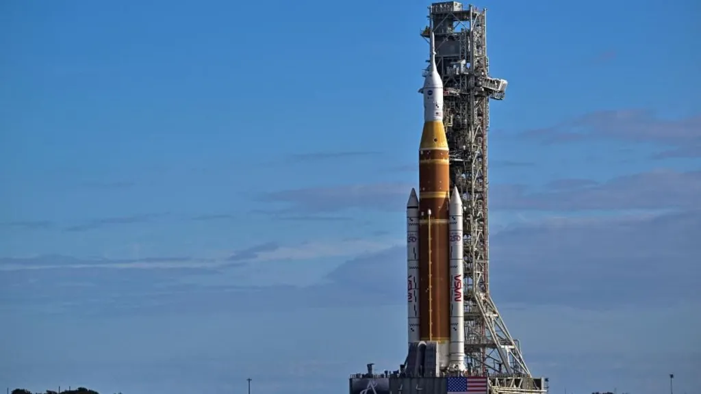 An image of a mega rocket in a stable position, surrounded by blue skies, as it was rolled towards the Kennedy Space Center in Cape Canaveral, Florida.