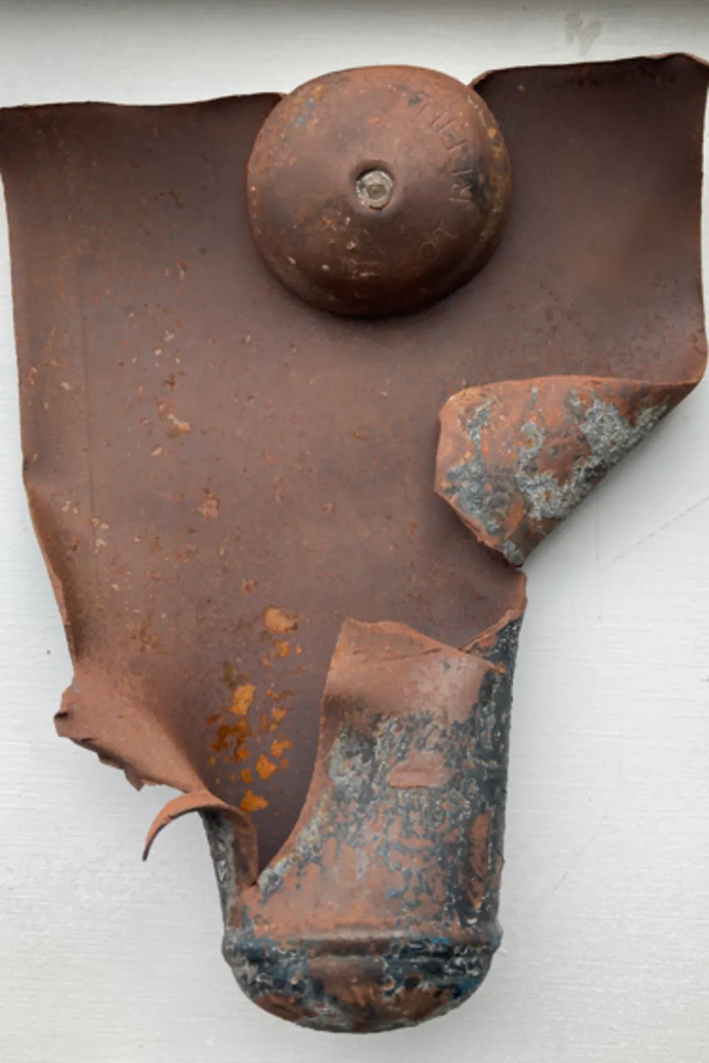 A ripped open canister that previously contained nitrous oxide, which has exploded after being heated at high temperature, or compressed, in a waste facility.