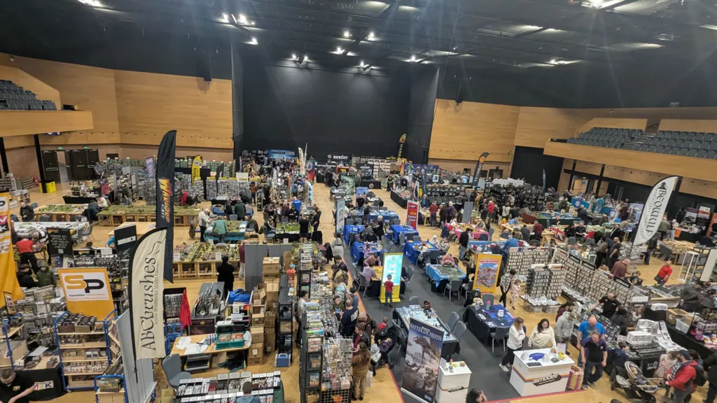 A large hall in Bournemouth International Centre is full of stalls and people. 