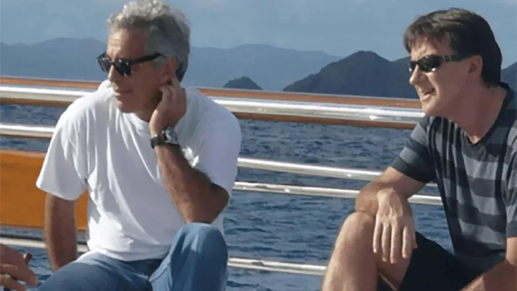 Jeffrey Epstein and Peter Mandelson wearing sunglasses as they sit on a yacht.