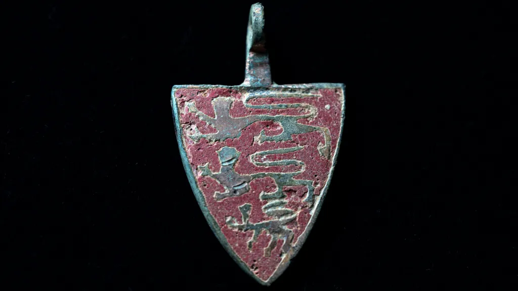 Gold 'three lions' pendant from the 13th-14th century. The heraldic device or harness pendant survives in incredible condition. 