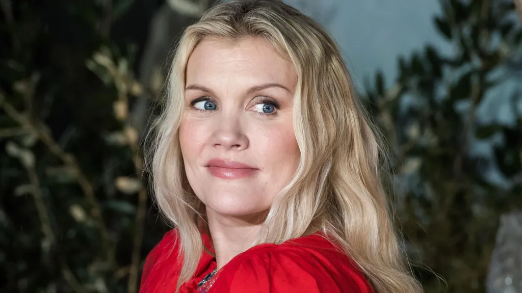 Emerald Fennell looks over her shoulder at the Wuthering Heights premiere in London, she has long blonde hair.