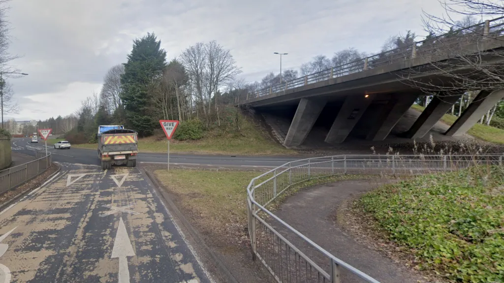 A lorry negotiates the interchange. A bridge carries the A9 above a road leading on to the A96.