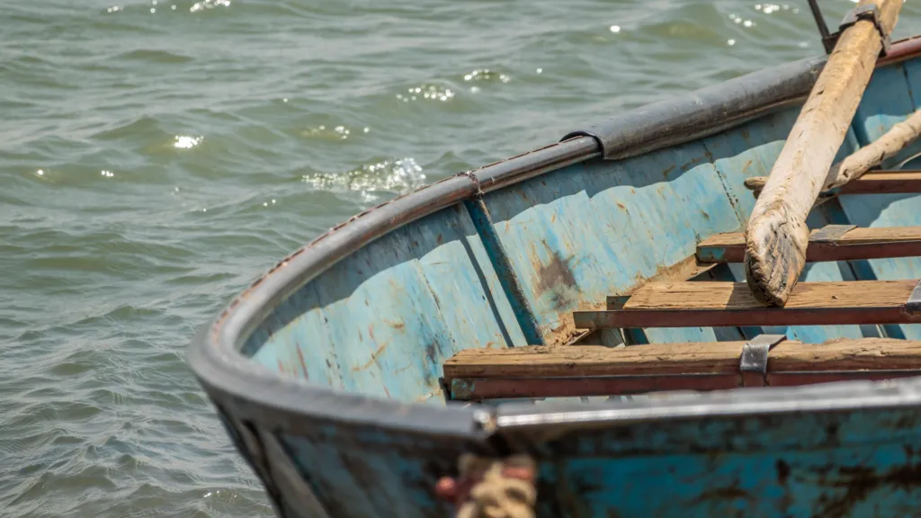 Old rusty fishing boat with flaking paint on the bank of the Nile in Sudan