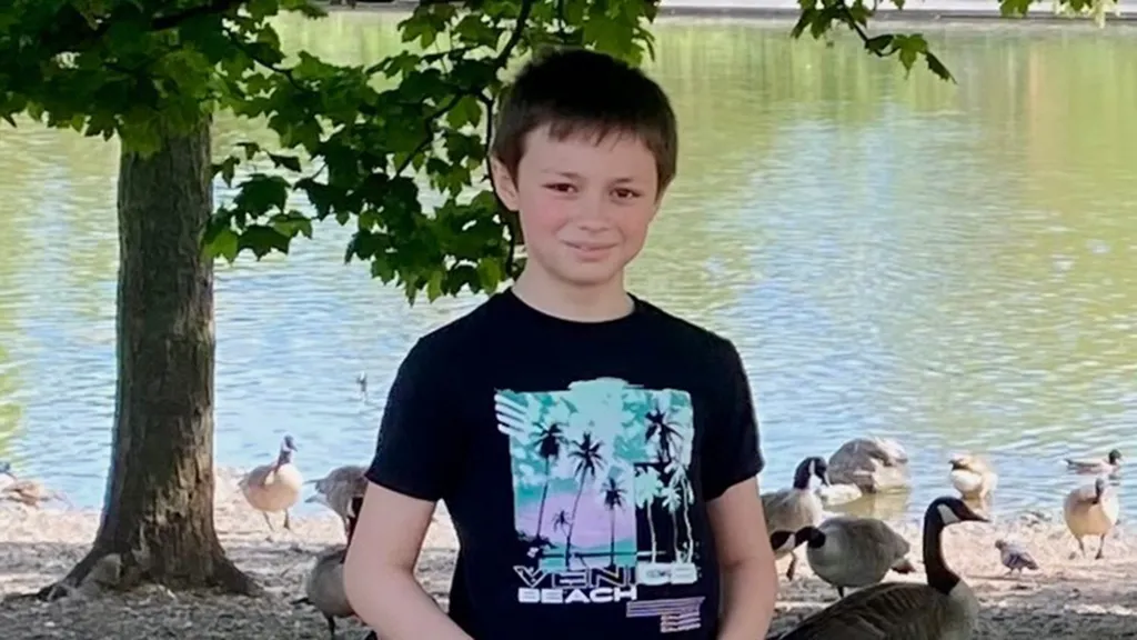 Leo Ross, a young boy with brown hair, smiling at the camera.