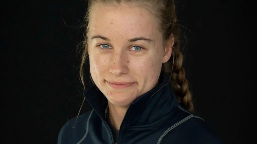 Charlotte Pressley who has light brown hair back from her face and pulled into a plait. She is wearing a dark blue fleece. 