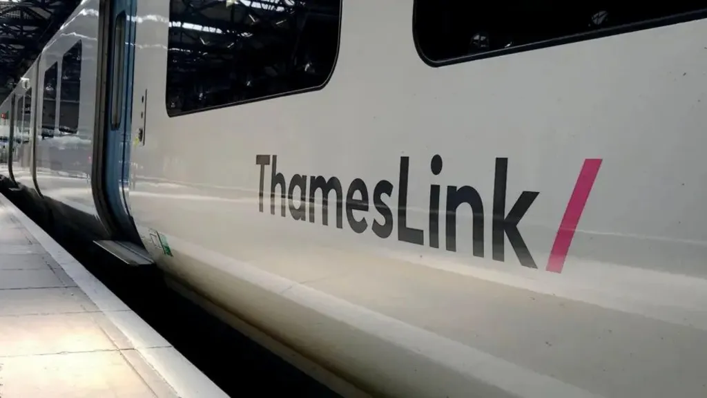 A close-up of a white train with "ThamesLink" in black on the side. The train has stopped at a platform.