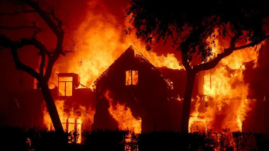 A night time picture of a homes in flames, as it is buffeted by strong winds, in Los Angeles during fires in January 2025