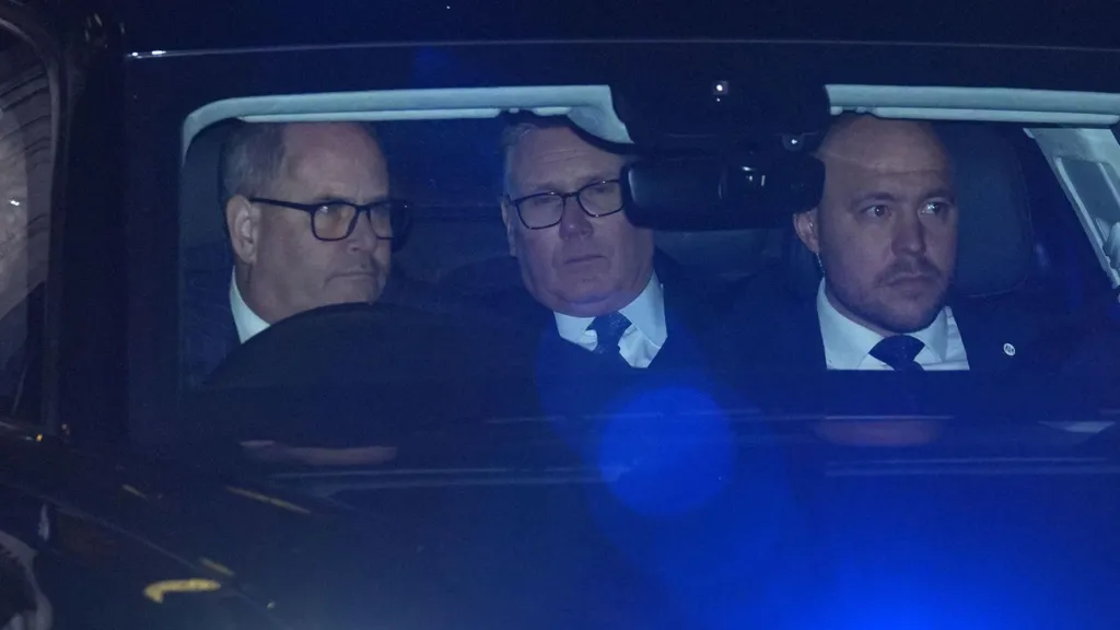 Sir Keir Starmer sits in the back seat of a car driving away from Downing Street. His eyes are half-closed.