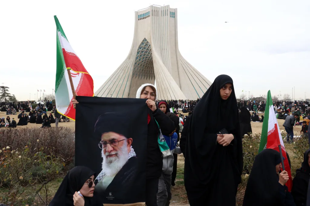 An Iranian woman holds up a photo of Ayatollah Ali Khamenei in Azadi Square, Tehran, Iran, during celebrations marking the 47th anniversary of the Islamic revolution (11 February 2026)