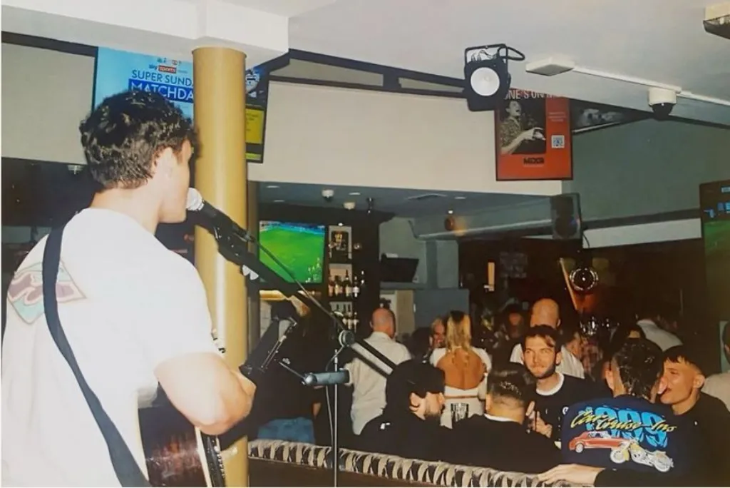 A man sings for a crowd who watch