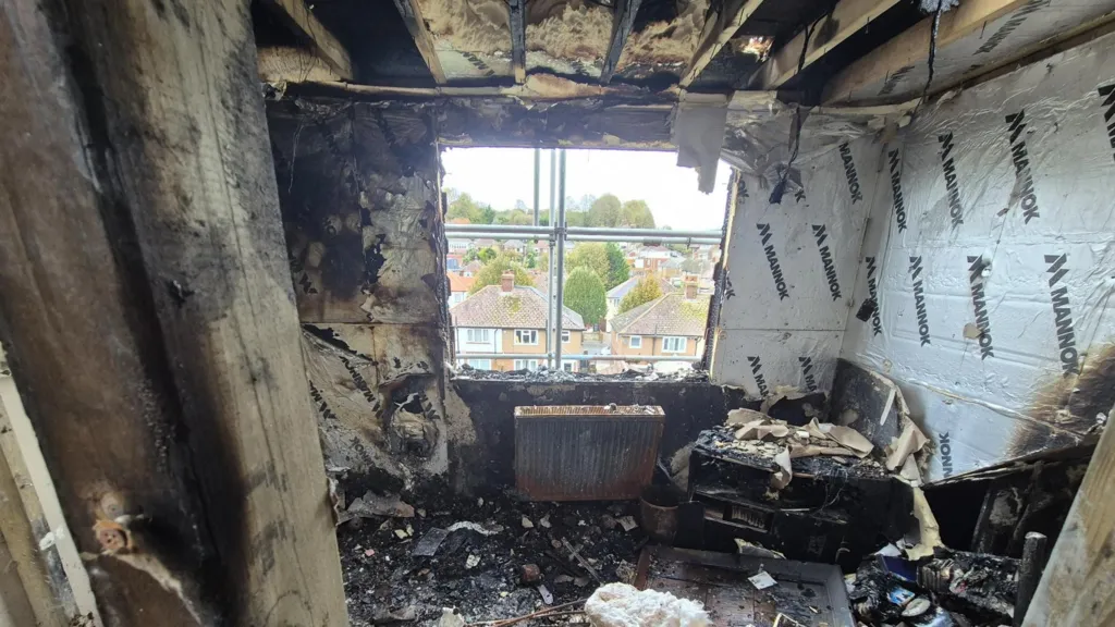 A burnt out room. Everything is black and charred.
