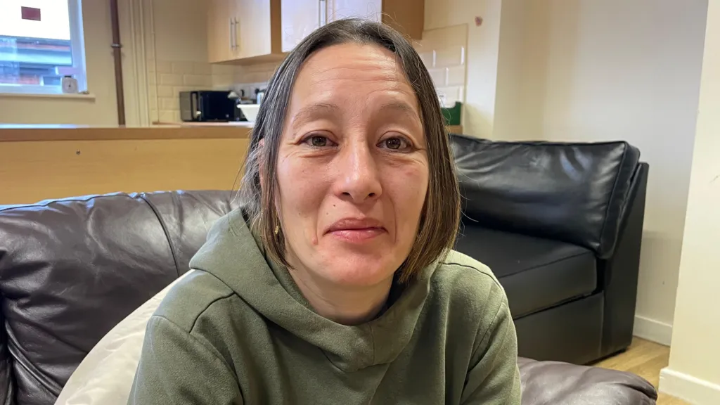 Lisa is wearing a green hoodie