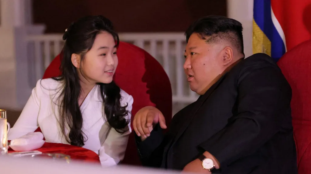 Kim Ju Ae (left) and Kim Jong Un (right) speak to each other
