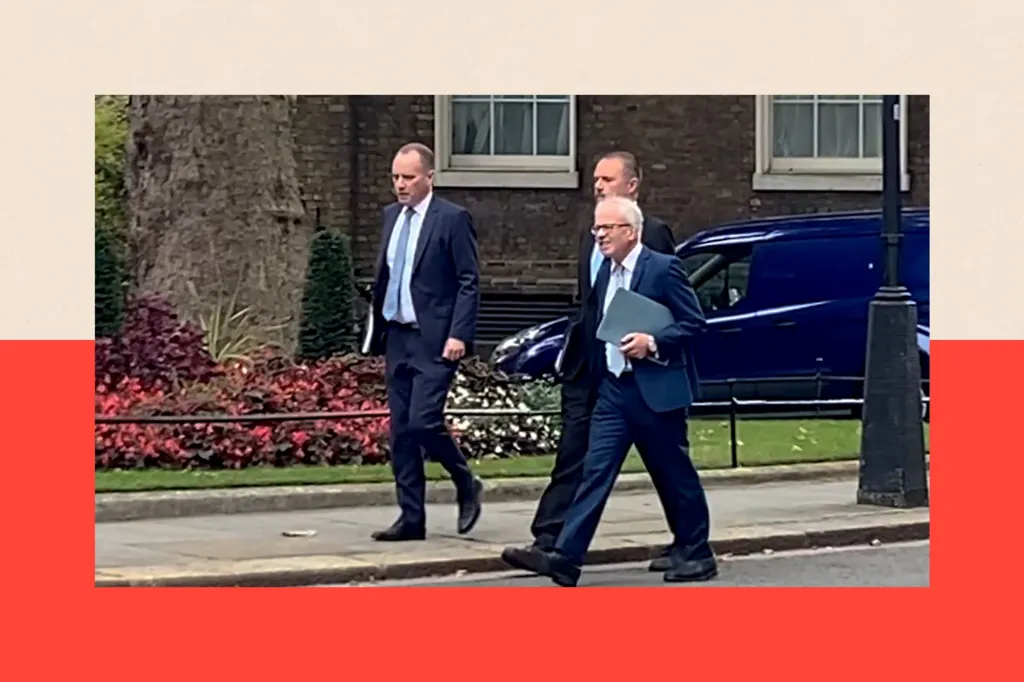 Richard Hughes (left), Andy King and David Miles (right) walk along a street wearing suits