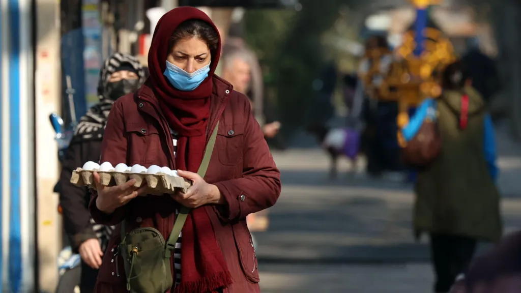 An Iranian woman holding an egg carton walks at a street market in Tehran, Iran, 07 January 2026.