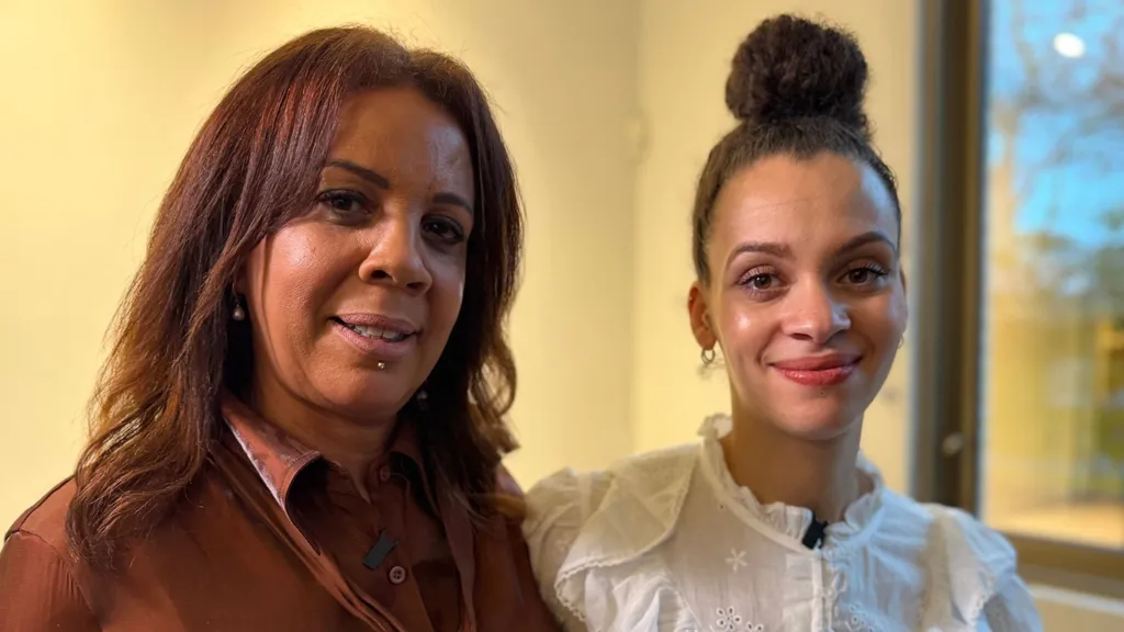 BBC Traitors stars Judy and Roxy stand next to each other, eyes to camera, smiling 