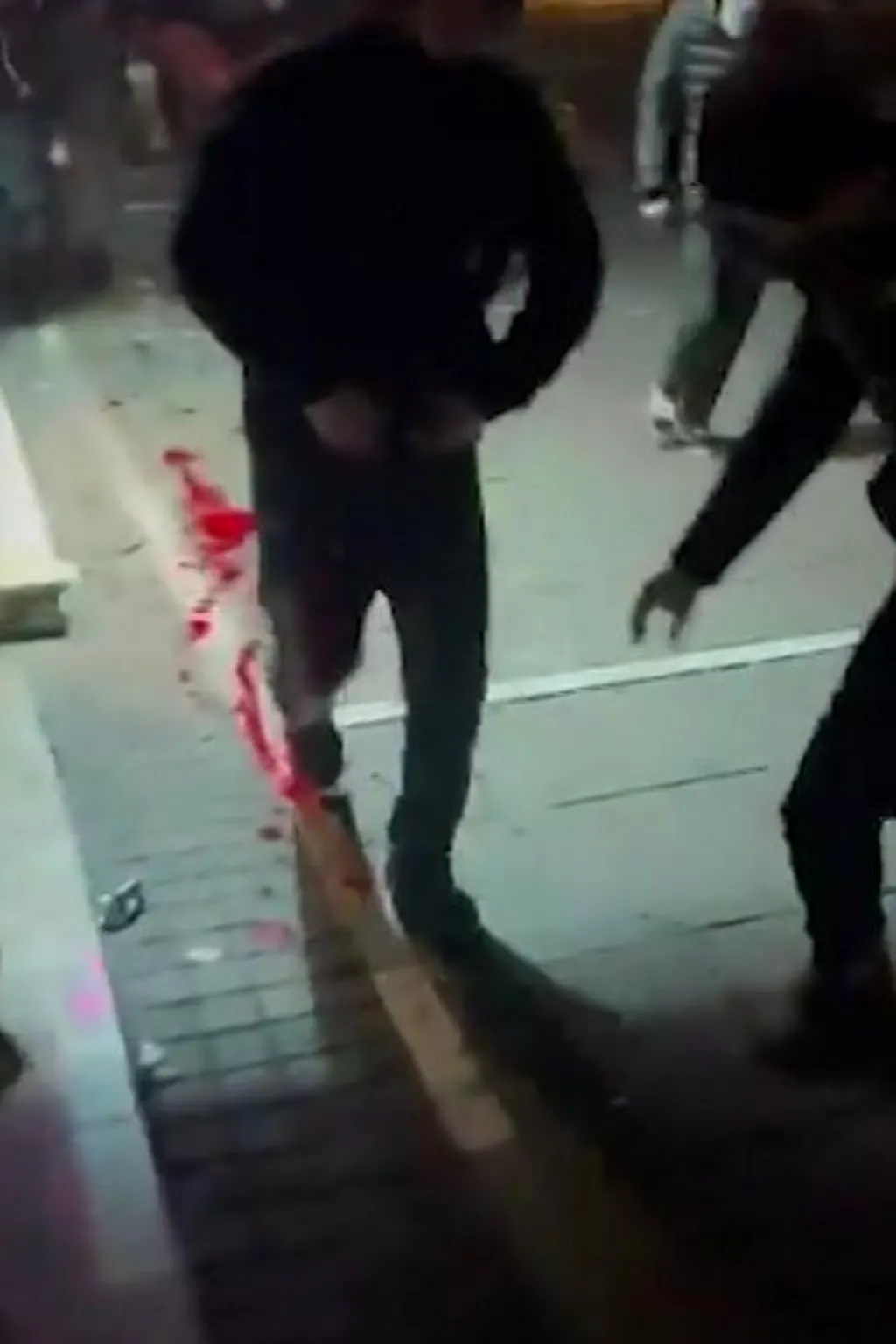 Screengrab from a video showing wounded people fleeing the sound of gunfire at a protest in eastern Tehran