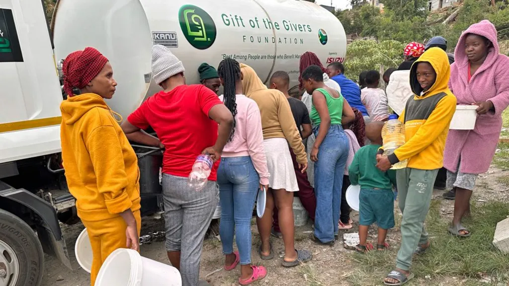 People queuing with buckets to get water from a Gift for Givers tanker