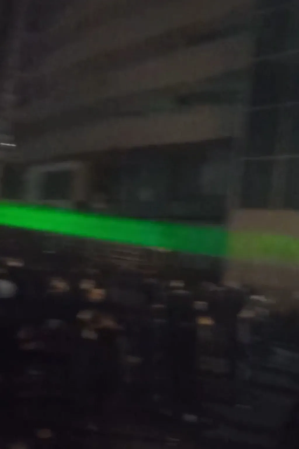 A green laser is seen during a protest in Iran
