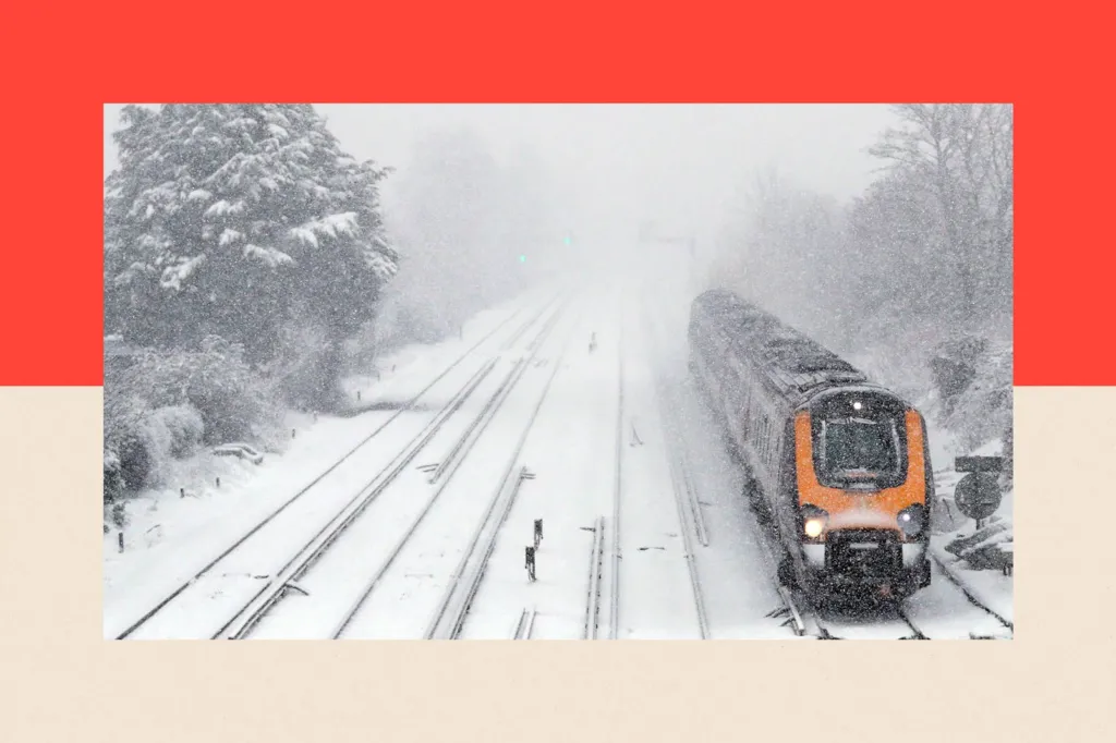 A passenger train travels through Worting Junction in Basingstoke, Hampshire in snowy conditions