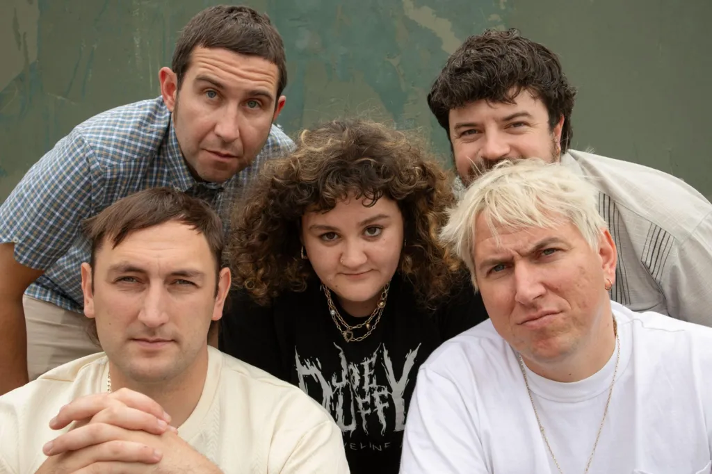 Band members pose for a group photo.