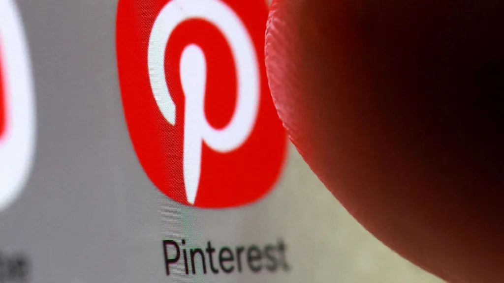 The red app icon for Pinterest, marked with a stylized letter P, on a smartphone. 
