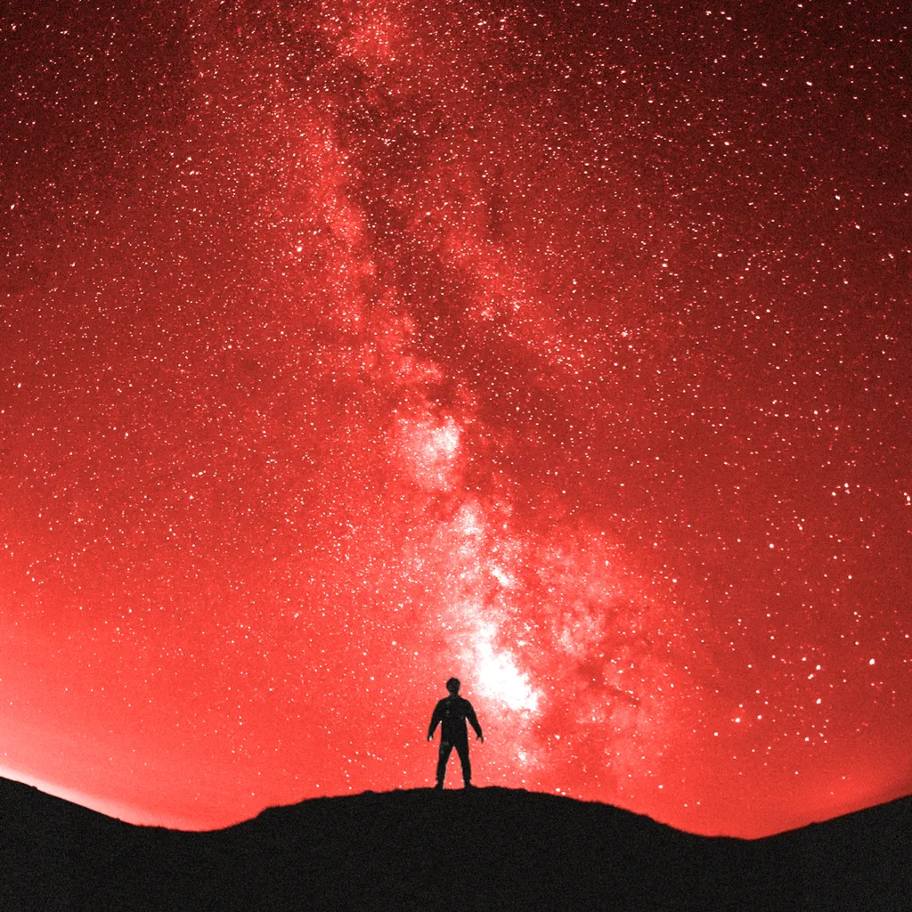 Treated image of a person standing under the galaxy
