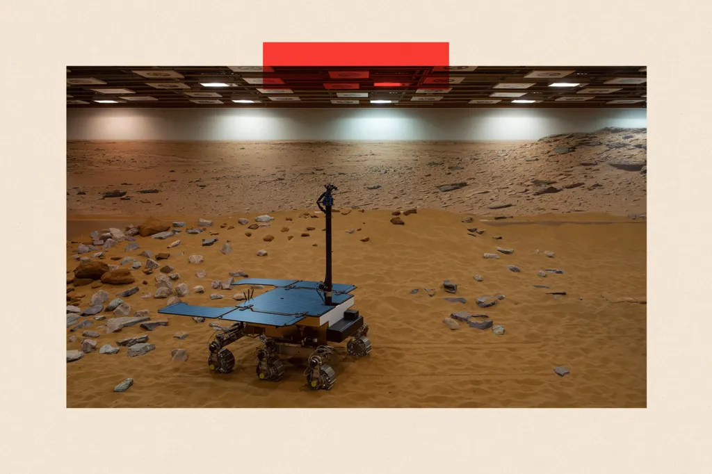A working prototype of the ExoMars rover on a yellow-orange sand-like surface