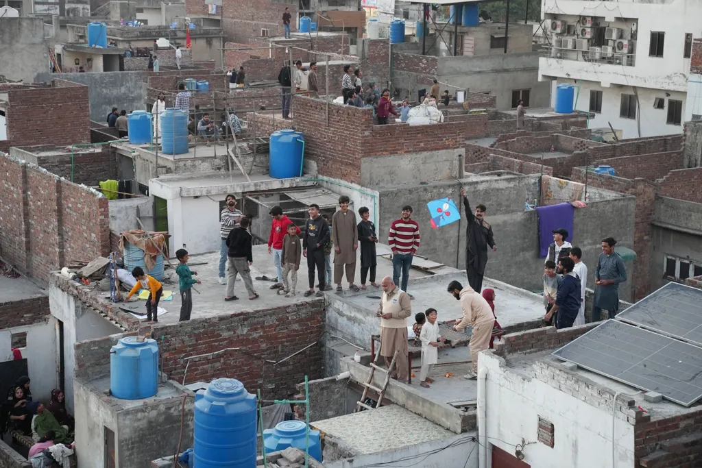 People on rooftops look up to the sky 