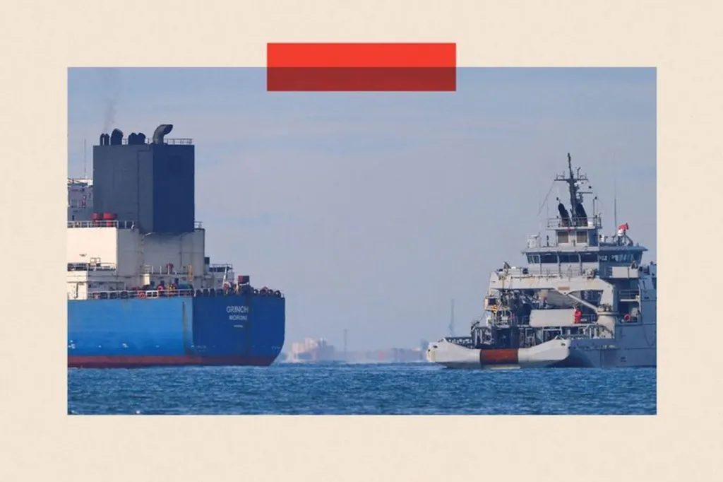 A blue tanker on the left being stopped by a white French boat on the right