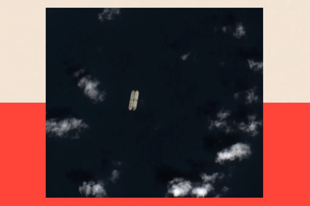 A black and white satellite image looking downwards to what is the sea. Two small lozenge shapes can be seen next to each other