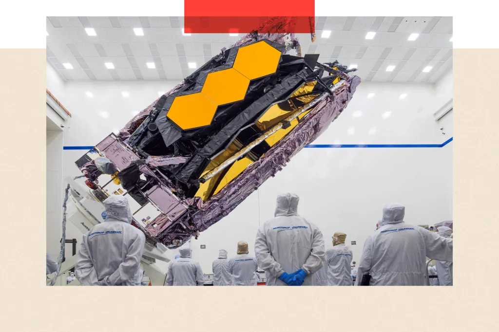 The James Webb Space Telescope is packed up for shipment, as people look on

