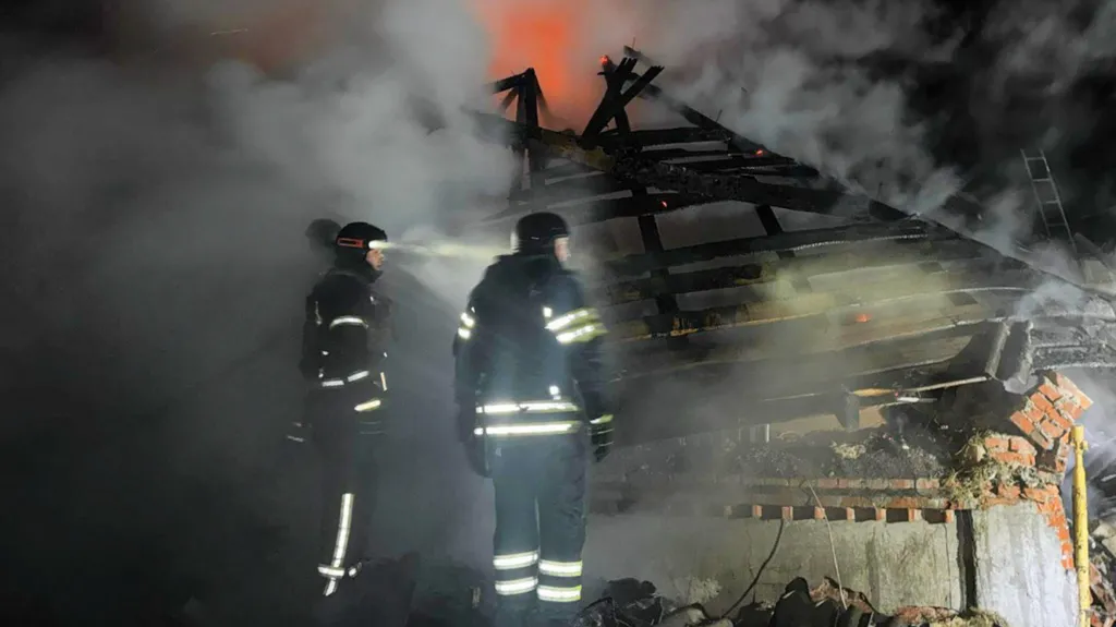 Ukrainian emergencies workers inspect a destroyed house in the town of Bohodukhiv, north-eastern Kharkiv region. Photo: 11 February 2026