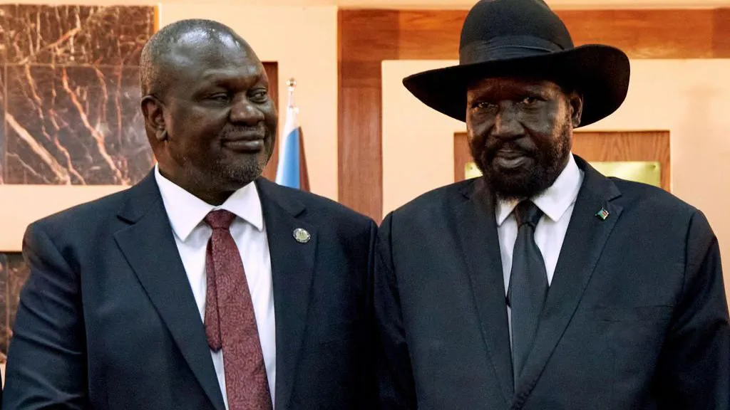 South Sudanese President Salva Kiir stands with his First Vice President Riek Machar as they attend his swearing-in ceremony at the State House